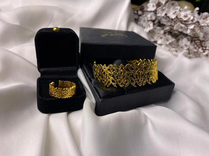Gold bracelets in black velvet boxes on a white fabric background
