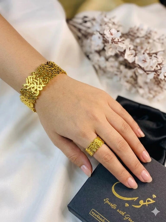 Gold bracelet and ring on a hand 